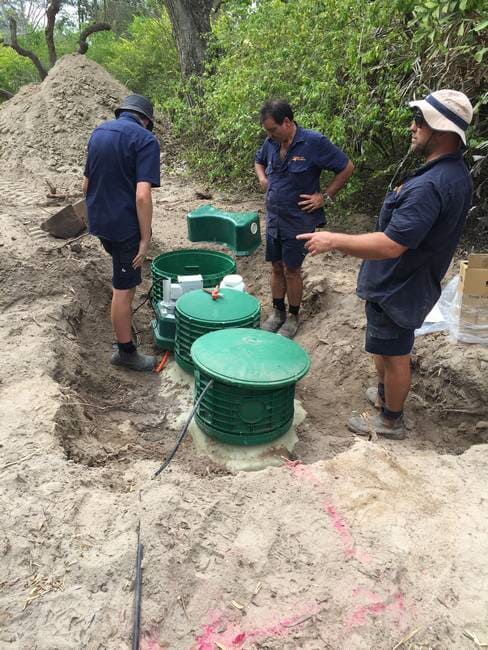 Plumbers in Gladstone installing series of septic tanks